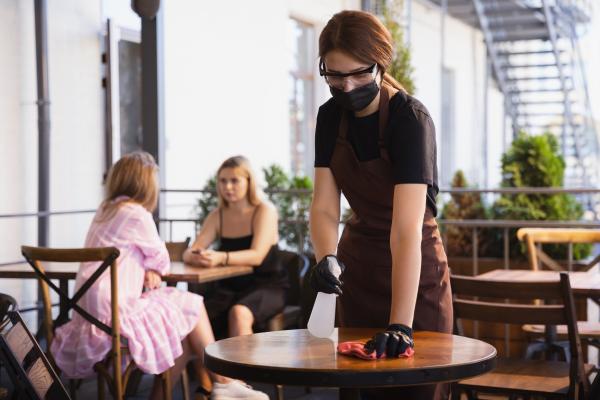 waitress works restaurant medical mask gloves during coronavirus pandemic