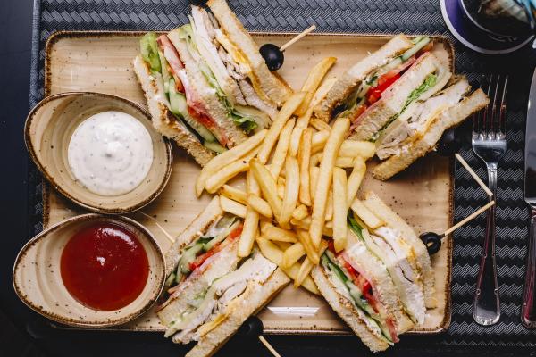 top view club sandwich served with french fries ketchup mayonnaise